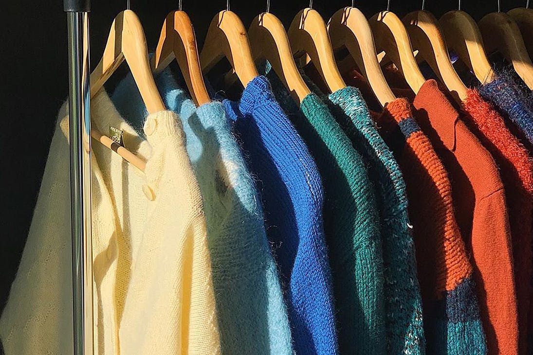 A line of cosy knits on a rail in an image from Fruit Bowl Vintage's Instagram account.